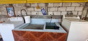 a kitchen with two washing machines and a sink at CASA BELINDA in Santiago Atitlán