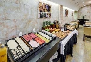 a buffet line with different types of food on display at Sercotel Puerta de la Catedral in Salamanca