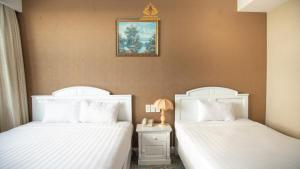 Postel nebo postele na pokoji v ubytování NINH KIỀU FORTUNELAND HoTel