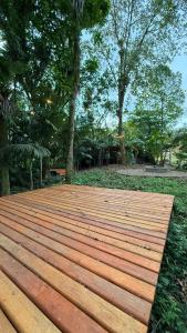 a wooden deck in the middle of a park at Camping do Bosque - Deck 01 in Rodeio