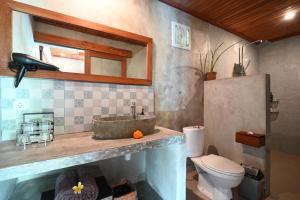 a bathroom with a sink and a toilet at Gami Ubud Villa in Ubud +32 photos