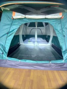 a blue and white tent with a bed in it at The living glamping and homestay in Penebel