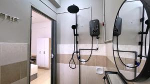 a bathroom with a shower with a phone on the wall at BM IconCity Landed Home by Wemestay - Near AutoCity, Juru, Penang Bridge in Bukit Mertajam +64 photos