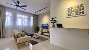 a living room with a couch and a ceiling fan at BM IconCity Landed Home by Wemestay - Near AutoCity, Juru, Penang Bridge in Bukit Mertajam