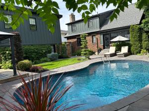 a swimming pool in front of a house at Garden Suite with Pool and Sauna in Brampton