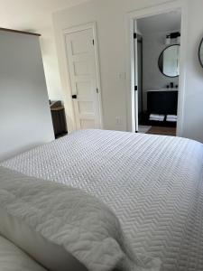 een slaapkamer met een wit bed en een badkamer bij Garden Suite with Pool and Sauna in Brampton +38 foto's