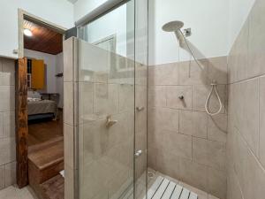 a shower with a glass door in a bathroom at Jardim da Música Tiradentes in Tiradentes +64 photos