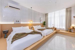 Katil atau katil-katil dalam bilik di Meizhou Island Diary Bed and Breakfast