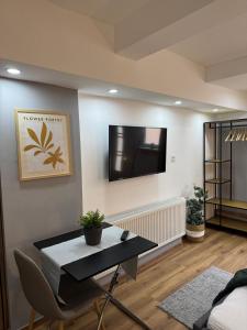 a living room with a table and a tv on a wall at M & E Ferienwohnung in Bad Mergentheim +64 photos