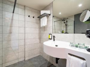 a bathroom with a sink and a mirror at Sercotel Playa Canteras in Las Palmas de Gran Canaria
