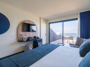 a hotel room with a bed and a view of the ocean at Sercotel Playa Canteras in Las Palmas de Gran Canaria