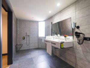 a bathroom with a sink and a shower at Sercotel Playa Canteras in Las Palmas de Gran Canaria