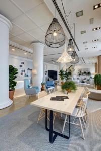 a living room with a table and chairs at Sercotel Kalma Sitges in Sitges