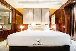 Postel nebo postele na pokoji v ubytování Moty Hotel
