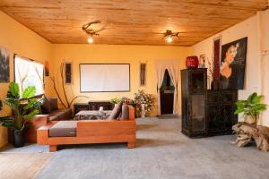 a living room with a couch and a screen at Junsu house in Sapa