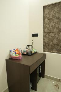 a wooden desk with a telephone on top of it at Manasa Water Park and Resort in Mangalore