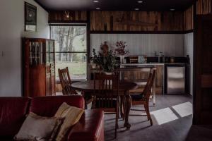 a kitchen and dining room with a table and chairs at Devon Downs in Eccleston