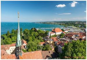 a view of a town with a steeple of a church at Konstanzer Ferienwohnungen in Konstanz