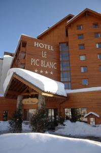 a large building with a sign on top of it at Le Pic Blanc in L'Alpe-d'Huez