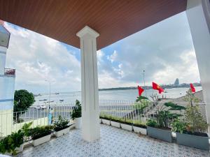 a view from the balcony of a building with a view of the ocean at HIKARU Homestay in Dong Hoi