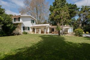 a white house with a large yard at ALTIDO Villa Valeverde in Sintra