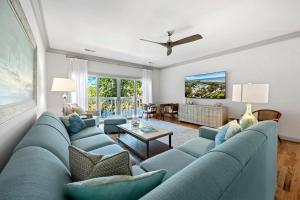 a living room with a large blue couch at Dieu Haven Villa villa in Georgetown