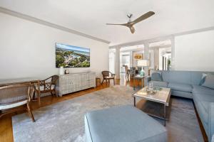 a living room with a blue couch and a table at Dieu Haven Villa villa in Georgetown