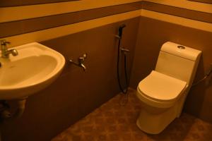 a bathroom with a toilet and a sink at Olive Homestay in Cochin