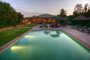 a swimming pool in the yard of a house at Hacienda Santa Cristina in Ovalle