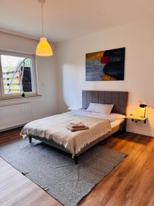 a bedroom with a bed with a rug and a window at Ovi Apartment in Vechta +5 photos