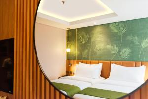 A bed or beds in a room at Ironwood Hotel