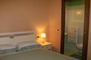 A bed or beds in a room at Locanda Fuoriporta
