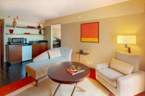 a living room with a couch and a table at Crowne Plaza - Chicago West Loop by IHG in Chicago
