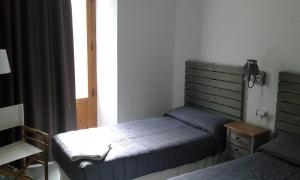 Łóżko lub łóżka w pokoju w obiekcie Granada Old Town Hostel