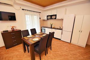 a kitchen and dining room with a table and chairs at Step to Kotor bay St-oliv in Kotor