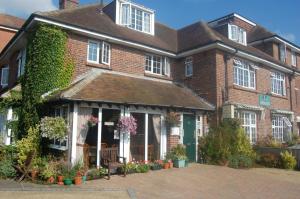 a large brick building with flowers in front of it at The Aldwick in Bognor Regis