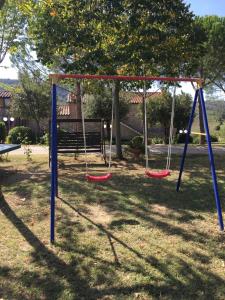 an empty swing set in a park at Casa Vacanza La Ginestra Paciano in Paciano