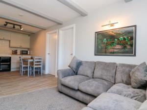 a living room with a couch and a kitchen at Ivy in Filey