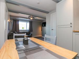 a kitchen and living room with a wooden table and a dining room at Ivy in Filey