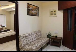 a living room with a couch and a bed at Family Friendly Guest House in Bengaluru +11 photos