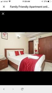 a bedroom with a large bed with red pillows at Family Friendly Guest House in Bengaluru