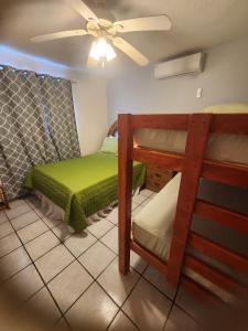 a bedroom with two bunk beds and a ceiling fan at Casa mexicana in San Felipe