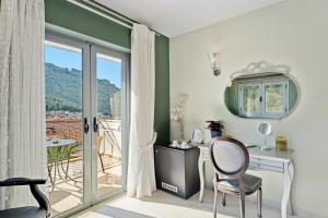 a room with a table and chairs and a balcony at Aerinon Guesthouse in Nafplio