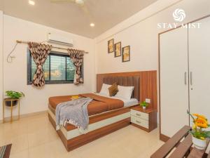 a bedroom with a bed and a window at Staymist - Casa Palais in Lonavala +19 photos