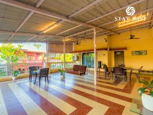 a lobby of a hotel with chairs and tables at Staymist - Casa Palais in Lonavala