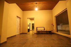 an empty hallway with a bench in a room at AMcroos in Negombo