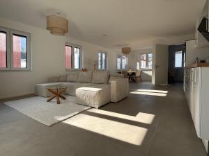 a living room with a couch and a table at Oldenburg City Apartments in Oldenburg