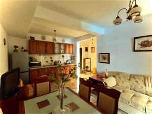 a living room and kitchen with a table and a couch at Olga Bashinskaya in Sutomore