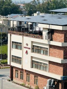 a building with a sign on the side of it at Aleph Residence 1 Bed Room Apt Citi Housing Main Road Gujranwala in Ado Rāi