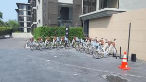 a row of bikes parked next to a building at Baan Mai Khao Beach Residence in Mai Khao Beach